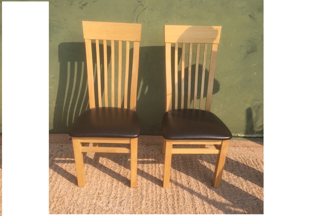 Pair of light Oak dining chairs with leather seats in very good condition. 108cm tall, 49cm to seat base.